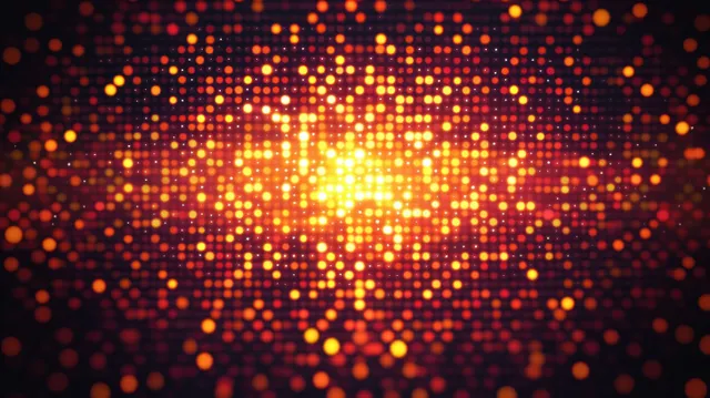 Orange and yellow glowing digital dots form a radiant abstract network burst on a dark background.