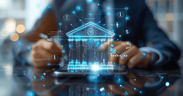 A businessman holds a smartphone with glowing banking and payment icons floating above his hands on a desk.