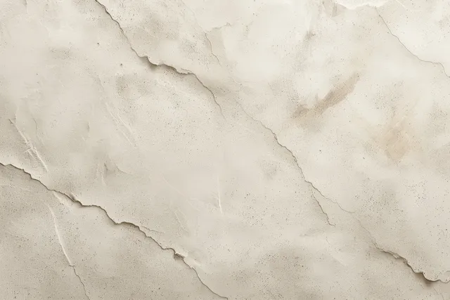 Beige marble stone surface texture with natural veining and fine cracks across the background.