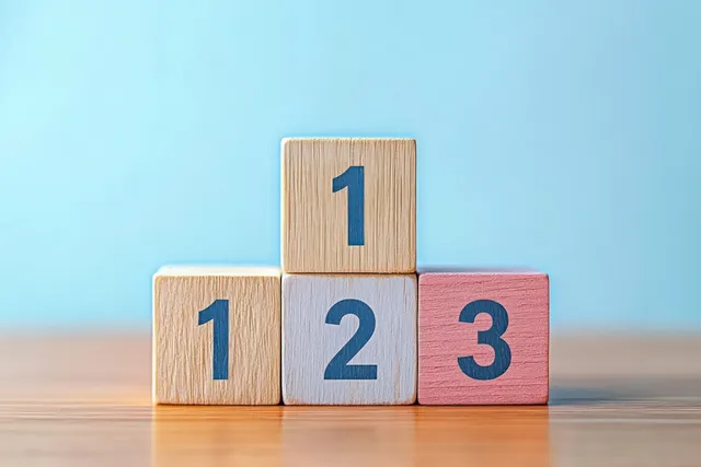 Numbered wooden blocks one two three stacked on a wooden surface