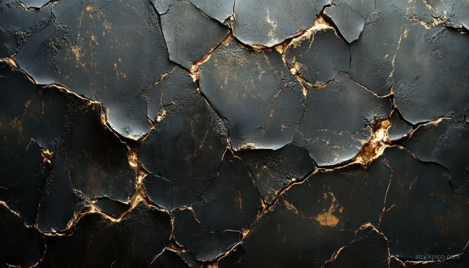 Cracked black stone surface with bright golden fissure lines and deep shadows.