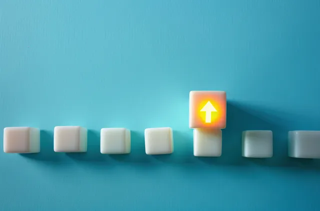 A row of white blocks on blue with one raised glowing block featuring a yellow upward arrow.