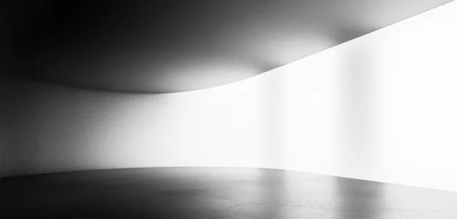 Monochrome abstract interior with a black-to-white gradient, smooth curved walls, and soft shadowed haze.
