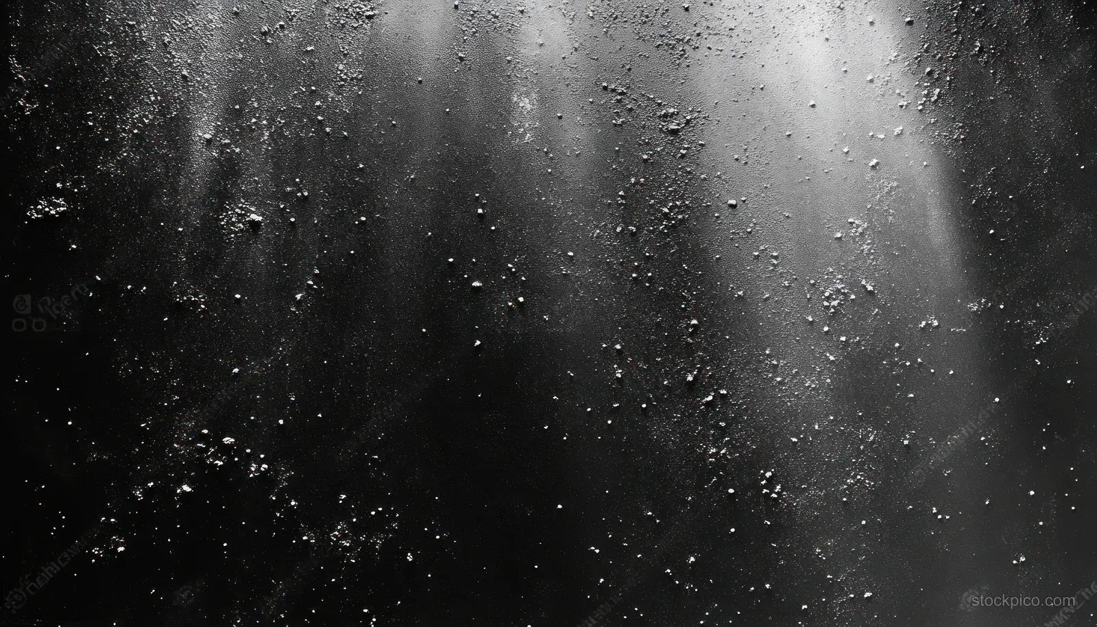 Grayscale textured abstract background with grainy speckles and faint scattered light reflections.