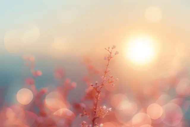 Soft sunrise glowing over misty mountains with pastel bokeh light