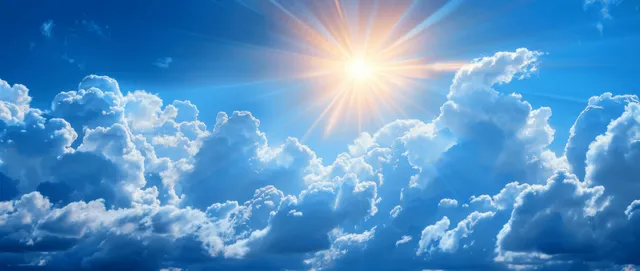 Sun rays breaking through blue sky clouds over a summer outdoor landscape