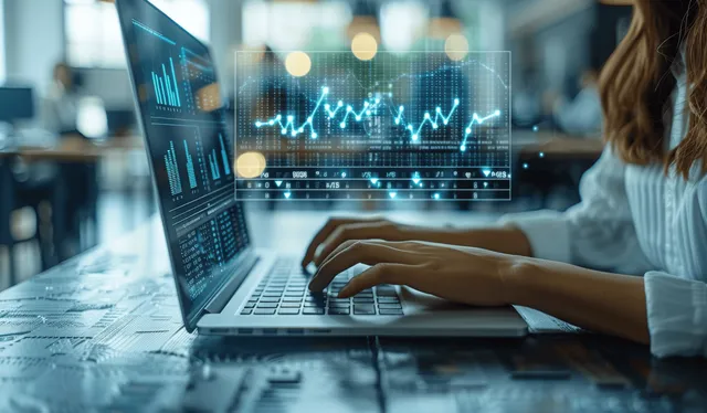 A businesswoman types on a laptop while a holographic flowchart of workflow steps floats in a blue office.