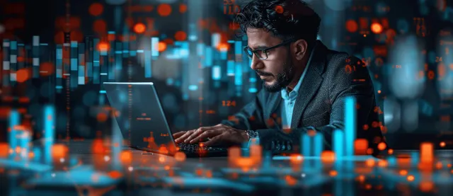 Analyst reviewing stock market charts on laptop with glowing financial data overlays
