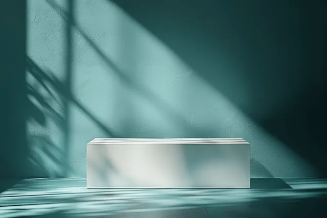Minimalist white bench in sunlit teal room with crisp window shadows