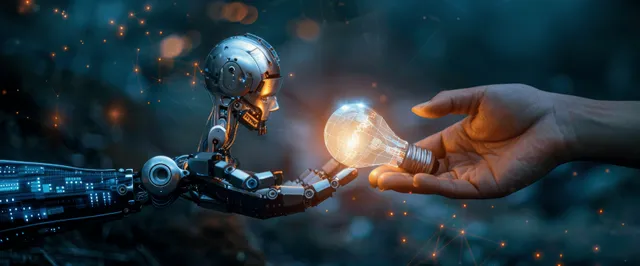 Robot hand touching human finger beside glowing light bulb