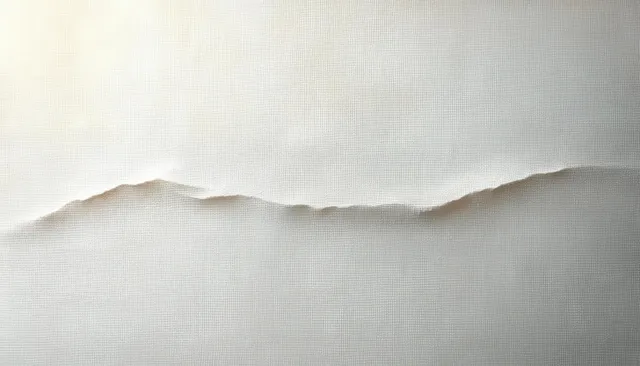 White canvas texture with soft light and subtle fabric folds on a neutral surface.