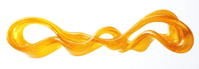 A glossy golden liquid ribbon twists into looping curves with a few bubbles suspended on a white background.