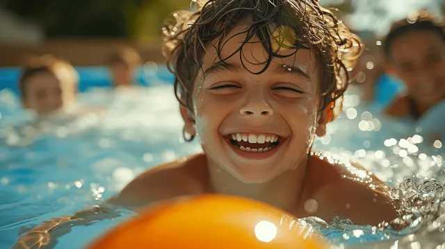 Laughing child splashing in an inflatable pool under bright summer sunlight