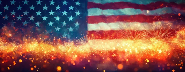 Fireworks burst across a waving American flag with glowing sparks and warm bokeh lights at night.