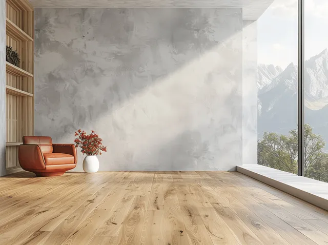 Empty modern room with wooden floor and light gray wall, with a window showing mountains and trees.