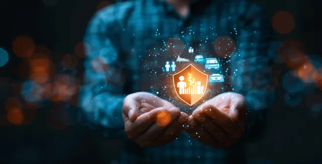 Businessman protecting a glowing home shield over hands with insurance icons backdrop