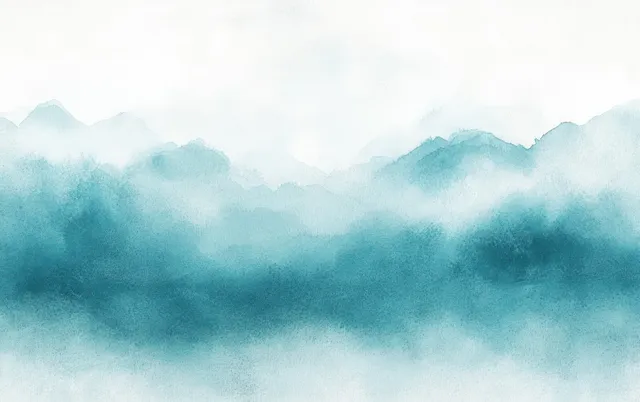 Misty layered mountain hills fade into a pale sky with blue teal haze