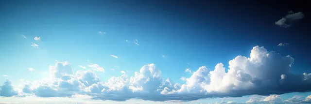 Vast blue sky with fluffy clouds drifting under bright morning sun