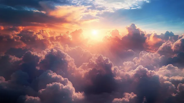 Sunrays break through golden fluffy clouds, illuminating a vast aerial sky panorama with depth and atmosphere.