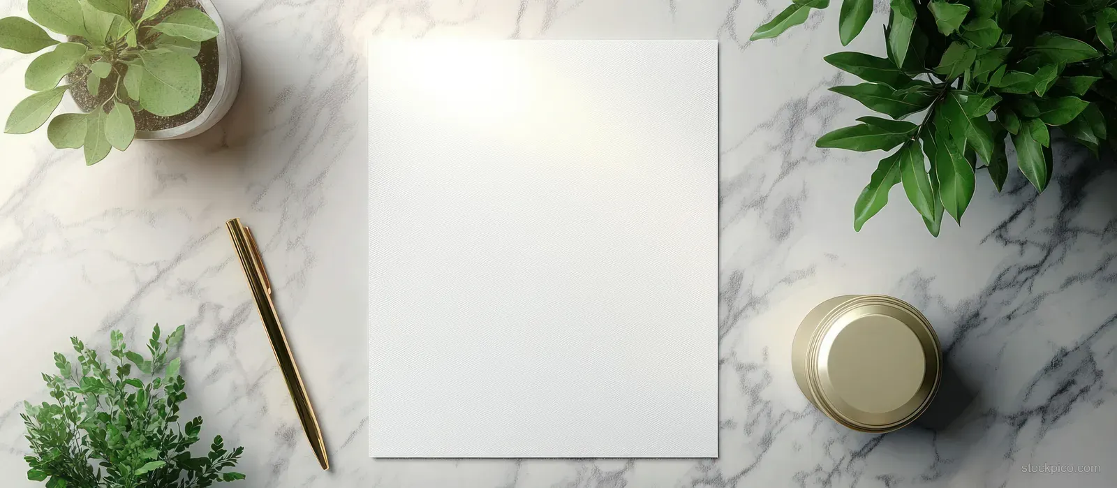 Blank white paper on a marble desk surrounded by green potted plants and gold pen and container.