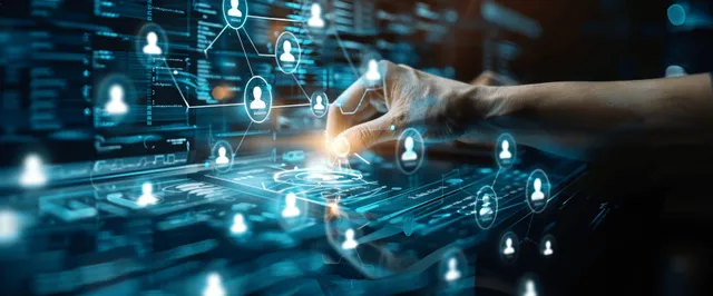 Hand connecting network nodes on digital screens with glowing data icons
