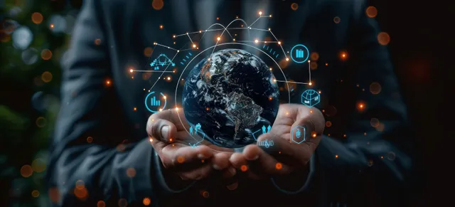 A businessman holding a glowing digital globe and checking analytics on a mobile screen surrounded by network icons.