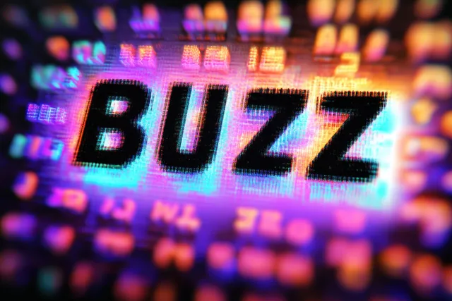 The word “buzz” glows in pixelated letters on a colorful digital screen with neon light effects.