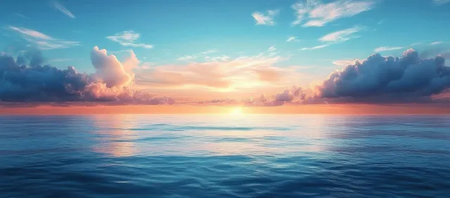 Pastel sunrise reflects on a calm tropical ocean as gentle waves roll toward a distant horizon.