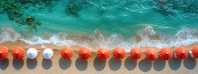 Aerial Beach Umbrellas Along Turquoise Waves in Bright Sunlight