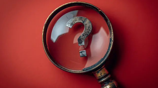 Magnifying glass reveals a red warning symbol with an exclamation mark on bold background