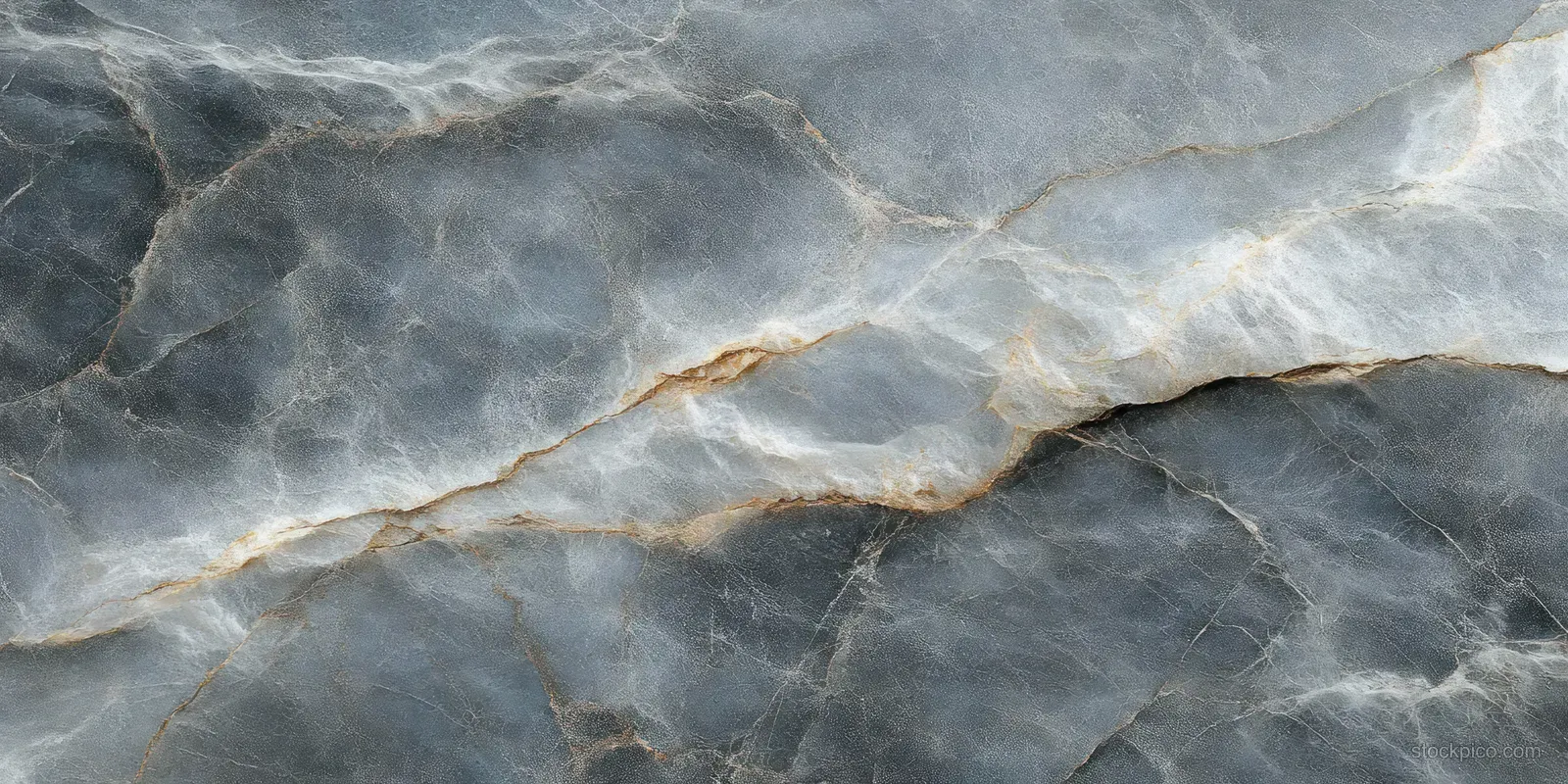 Close-up of a gray marble slab with swirling white and brown veins forming an organic pattern.