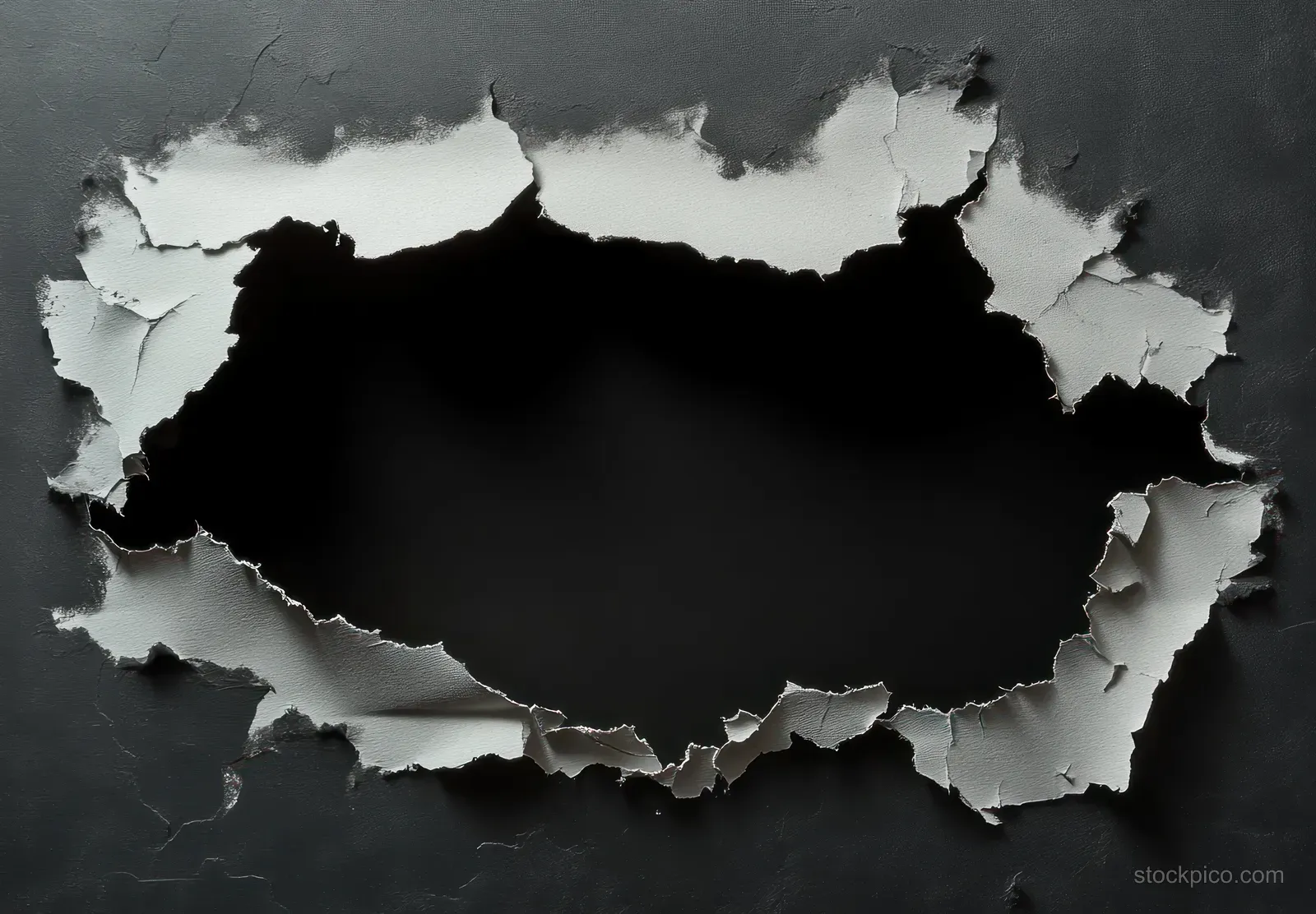 A dark wall has a large irregular hole with peeling cracked paint exposing a black void behind.