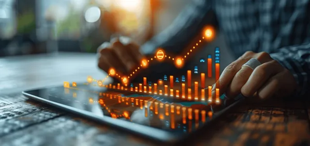 Businessman analyzing revenue charts on a tablet with glowing upward indicators