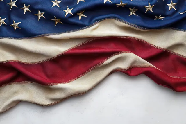 Waving American flag close-up with starry blue section and red-and-white striped fabric texture.
