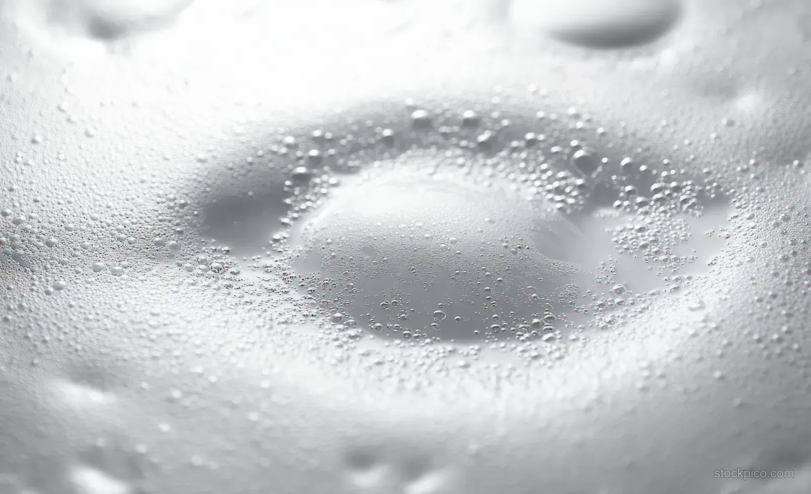 Close-up of clustered white foam bubbles with smooth surface texture and soft highlights.