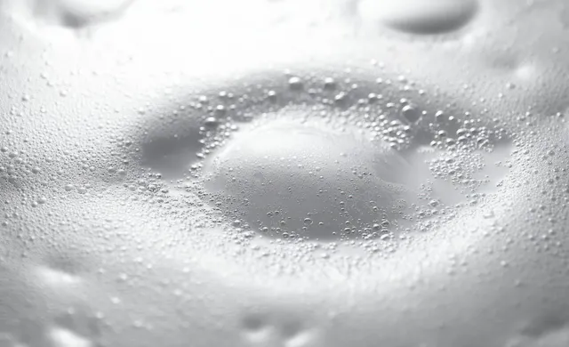 Close-up of clustered white foam bubbles with smooth surface texture and soft highlights.