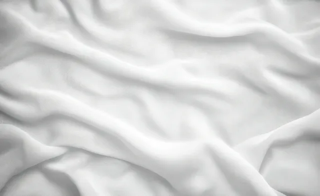 Soft white fabric with gentle folds and diffuse light for a calm flowing texture