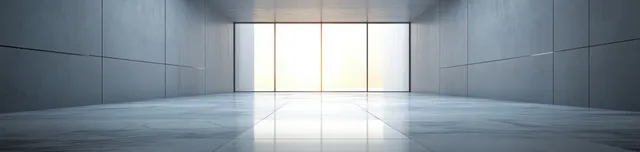 A minimalist interior hall features gray walls and a polished marble floor, creating a calm and contemporary atmosphere.