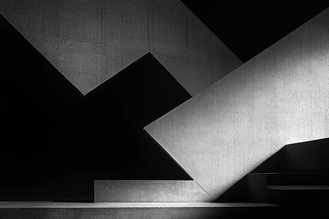 Monochrome minimalist concrete interior where diagonal beams cast sharp geometric shadows across steps.