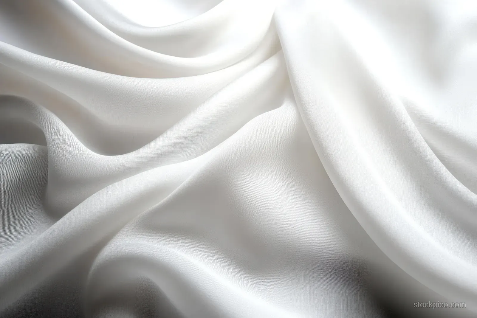 White satin fabric drapes across the frame with smooth folds and subtle gray ripple highlights.