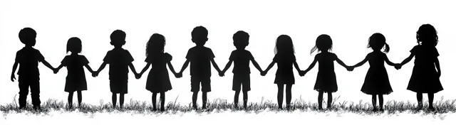 Backlit silhouettes of children holding hands standing on a grassy field.