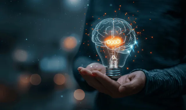 A businessman holds a glowing light bulb with a holographic brain on a dark digital background.