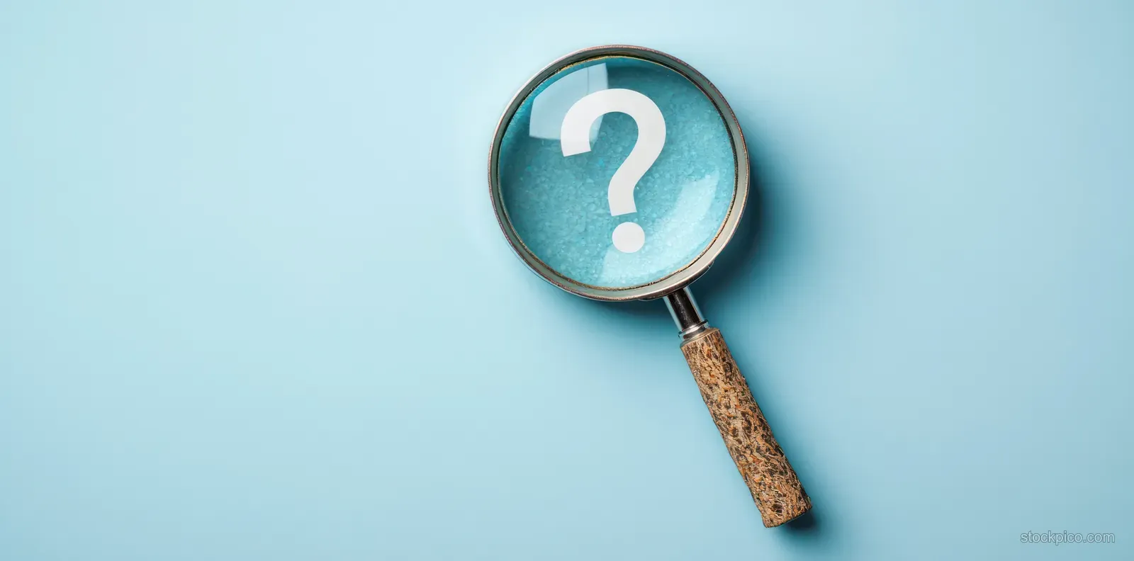 Magnifying glass with wooden handle enlarging a white question mark on a light blue background.