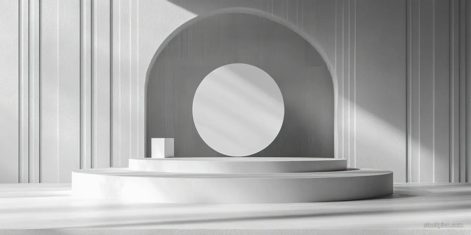 Minimal white podium platform on a studio stage under an arched opening with striped light wall background.