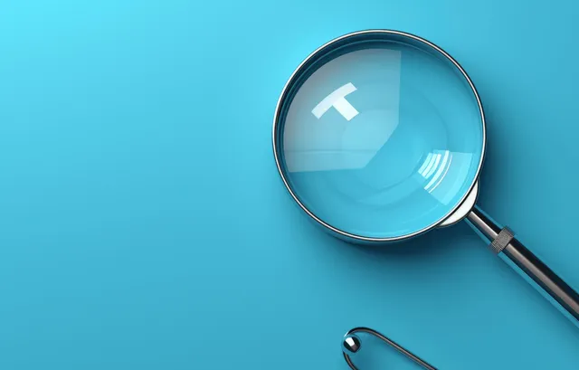 White plus sign in magnifying glass icon on blue health value concept background