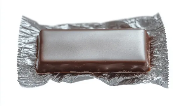 A rectangular chocolate bar is partially unwrapped from silver foil against a clean white background.