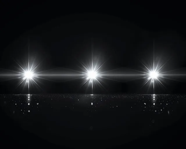 White lens flare orbs glow across black background with radiant light rays