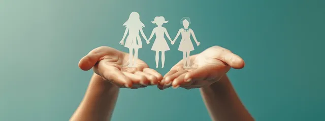 Hands hold paper cutout family figures over a turquoise background, suggesting support and mental well-being.