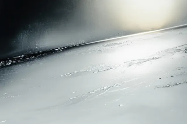 Close-up of a cracked frozen ice sheet with smooth frost patterns under soft winter light.