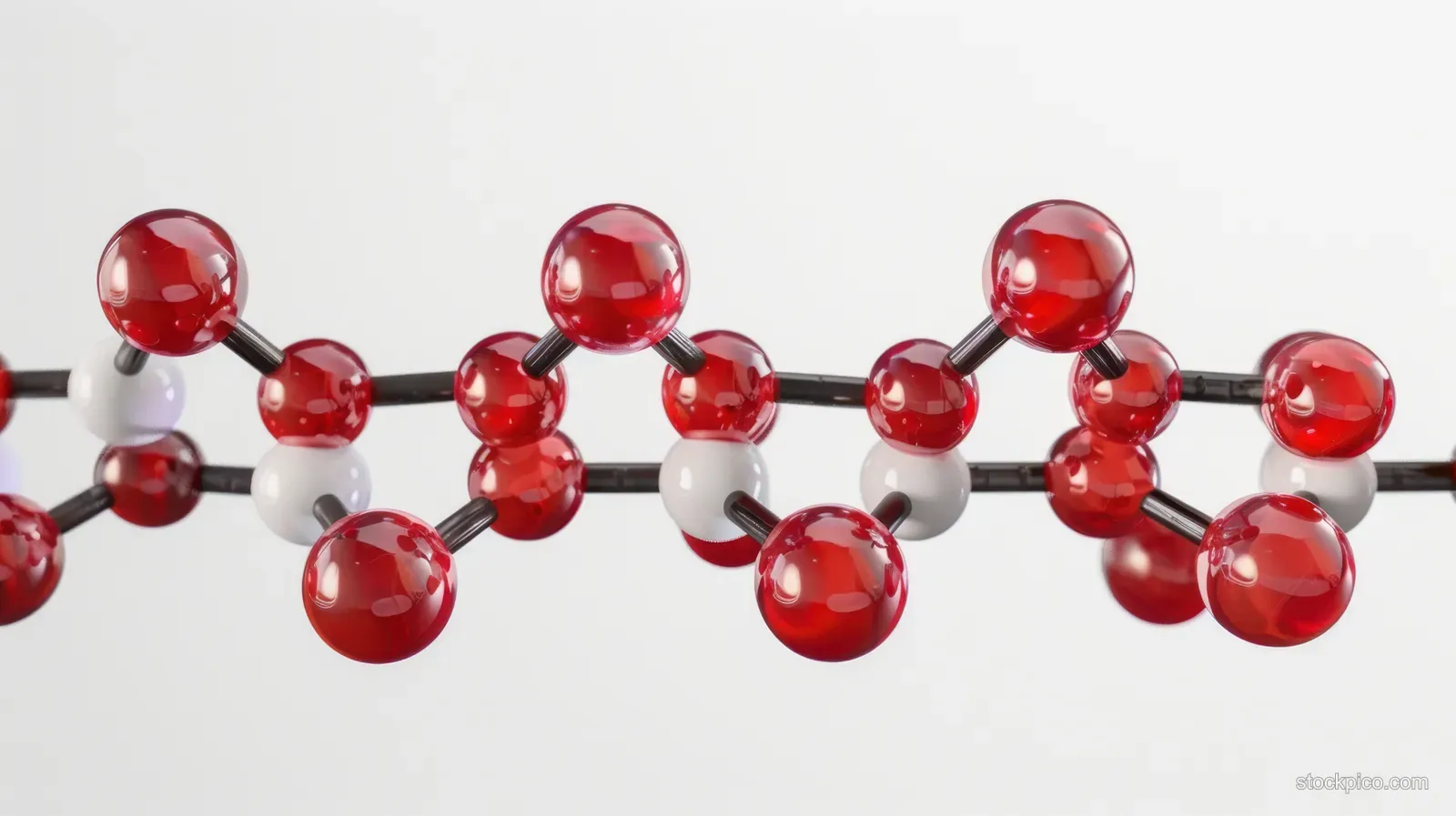 Close-up molecular model with red and white spheres joined by black rods on a white background.
